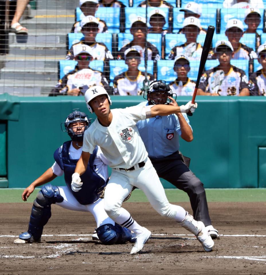 　４回、左前に先制適時打を放つ日大三・豊泉悠斗（捕手　関東一・中浜一葵）＝撮影・山口登