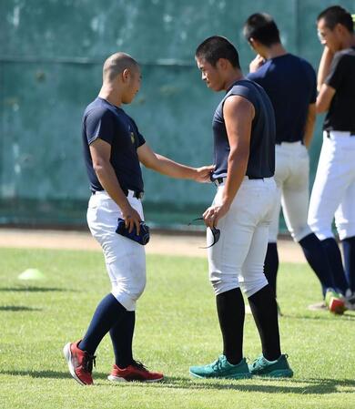 　練習中、近藤優樹（左）に腹筋を誇示する日大三・田中諒（撮影・開出牧）