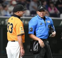 　８回、山口球審（右）に笑顔を見せながら選手交代を告げる阿部監督（撮影・佐藤厚）