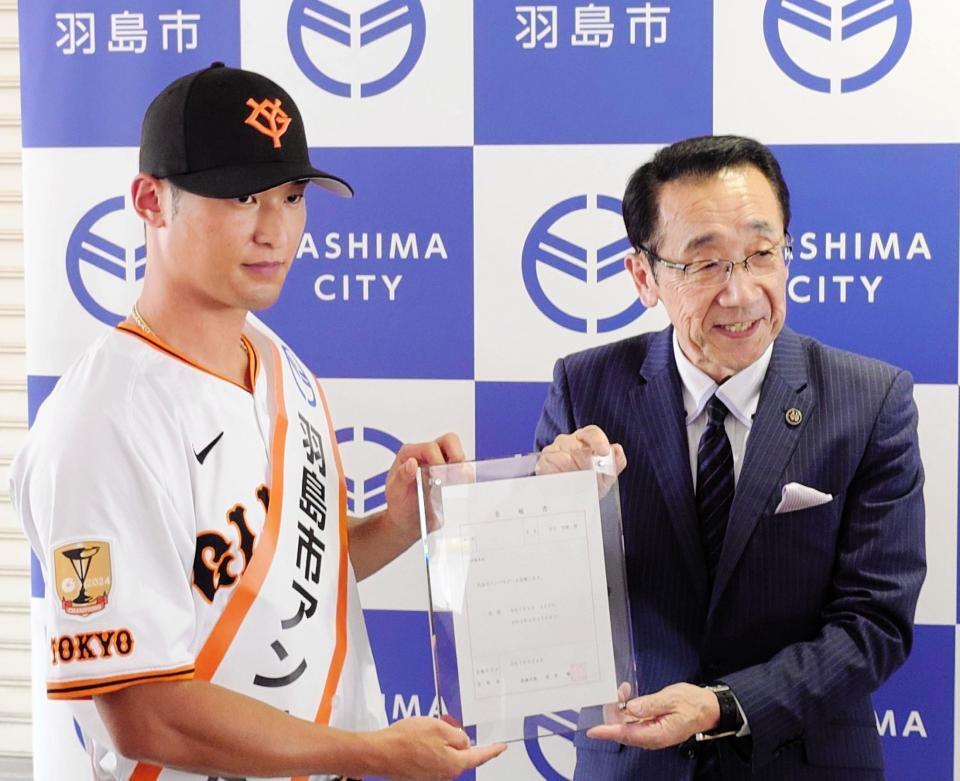 　羽島市アンバサダーに就任した巨人の吉川（左）に委嘱状を手渡す松井市長
