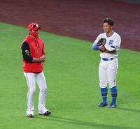 　試合前、今川（右）にスローイングの指導をする新庄監督（撮影・中島達哉）