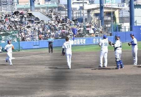 花束を掲げる岡田