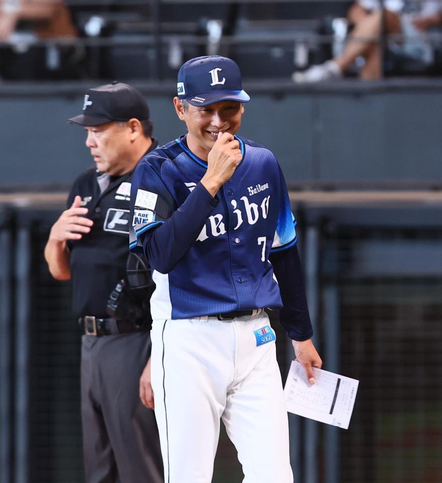 　新庄監督とメンバー表を交換し、笑みを浮かべながらベンチに戻る西口監督（右）＝撮影・中島達哉