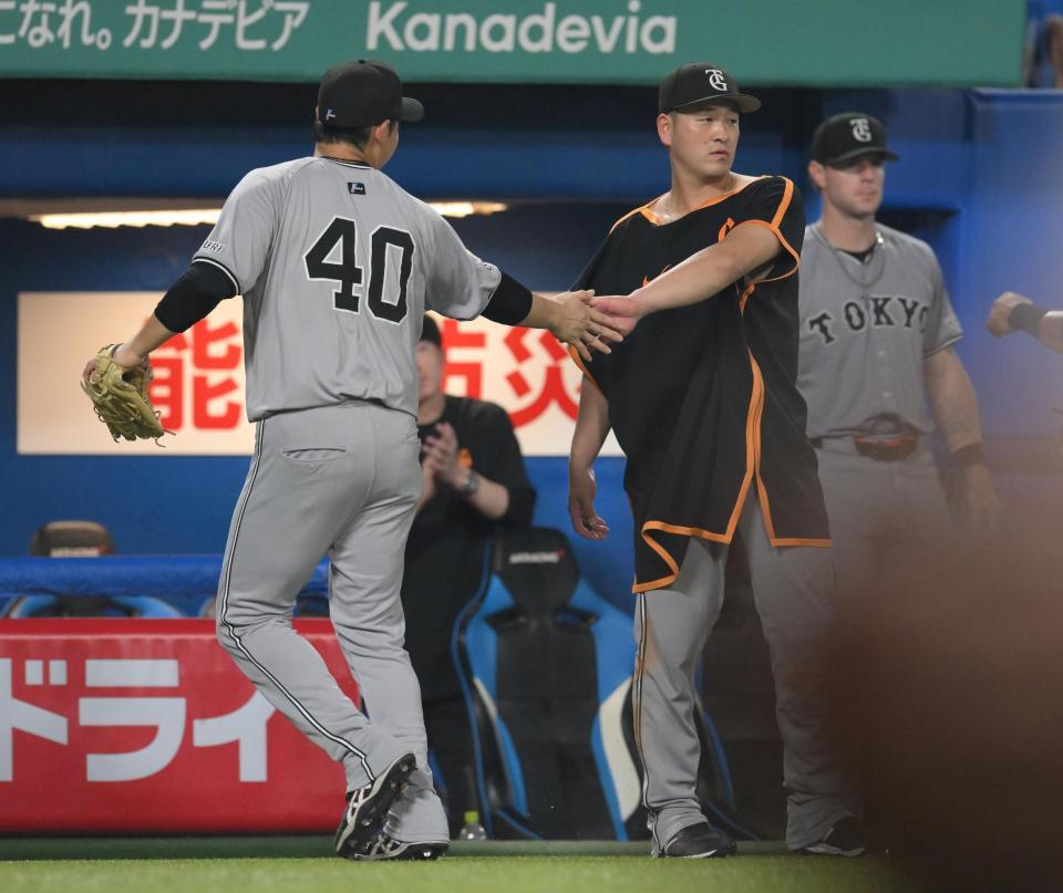 　８回が終わり、アイシング姿でナインを迎える岸田（右）＝撮影・伊藤笙子