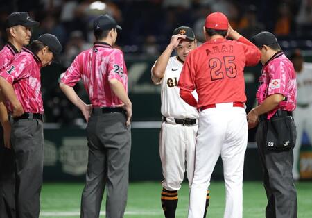 　メンバー表交換でピンクユニフォームを着用する審判員（撮影・西岡正）