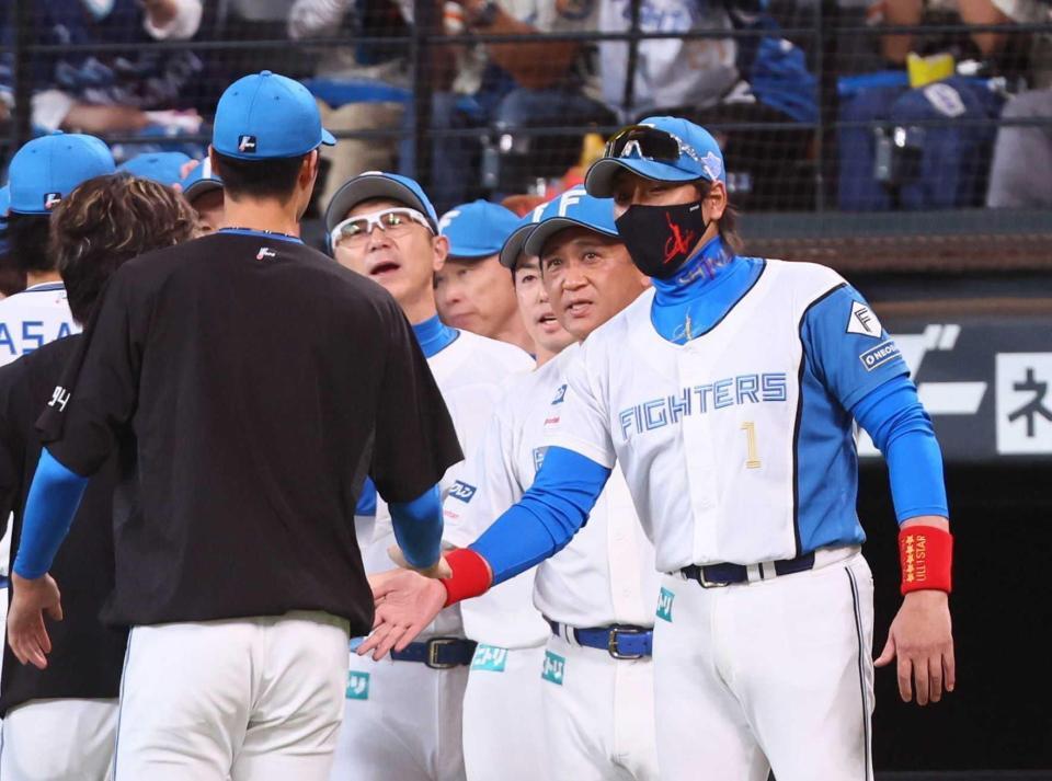 　ナインを迎える新庄監督（右）（撮影・中島達哉）