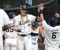 　７回、逆転３ランを放ち、ナインとタッチを交わすネビン（撮影・西岡正）