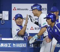 　７回、守備の乱れの間に生還した二走・筒香とタッチを交わす三浦監督（左）