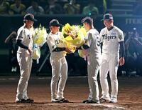 　岩崎（右）、梅野（中央）、岩貞（左）から花束を受け取る原口（撮影・立川洋一郎）