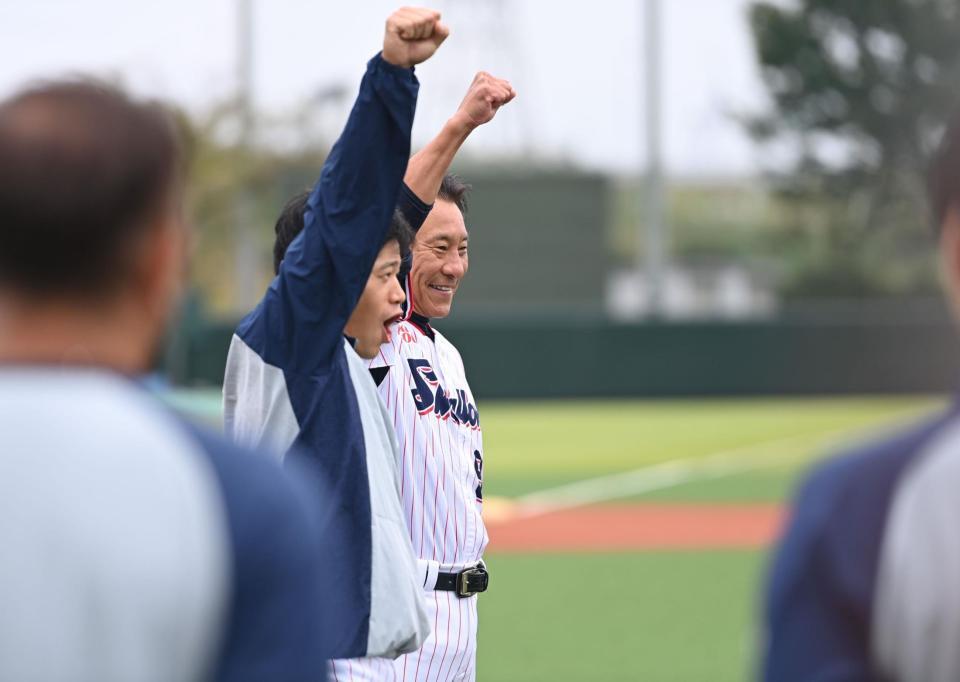 　練習前のミーティングで塩見（手前）と共にガッツポーズを決める池山新監督（撮影・開出牧）