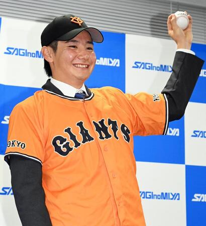 　巨人から１位指名を受け、ボールを手にポーズをとる鷺宮製作所・竹丸和幸