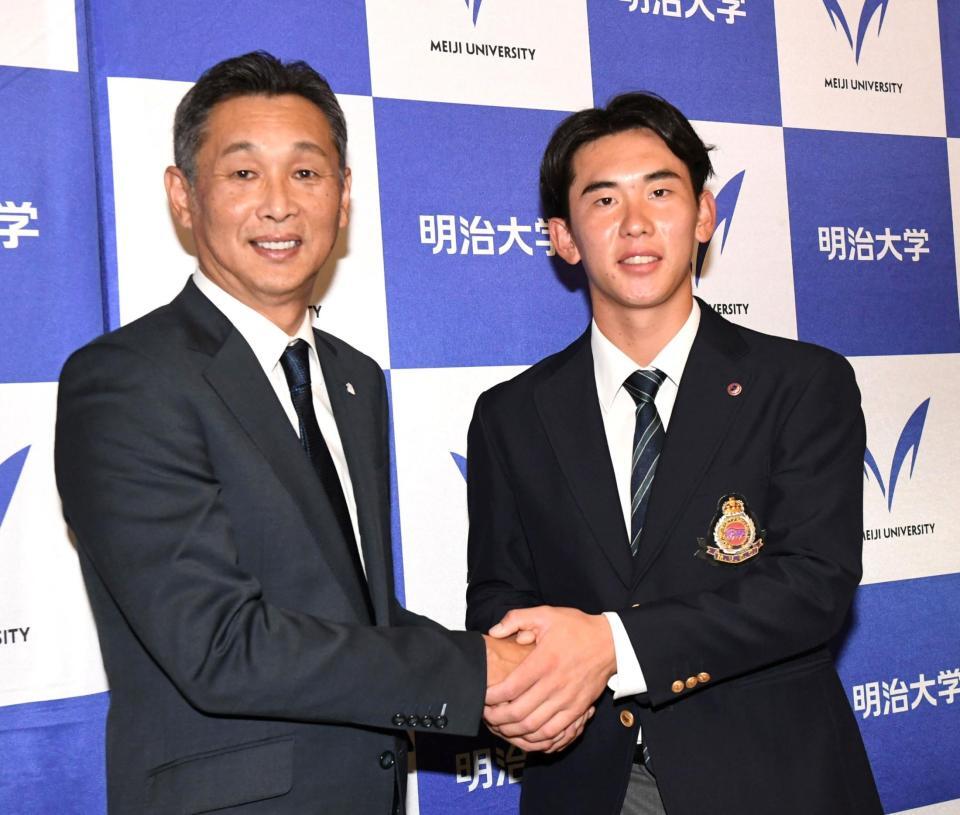 　ドラフト会場から駆けつけた西口監督（左）と握手を交わす明大・小島大河（撮影・佐藤厚）