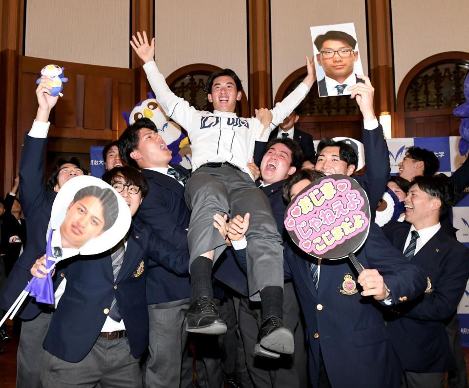 　西武から１位指名され、仲間の手で胴上げされる明大・小島大河（中央）＝撮影・佐藤厚