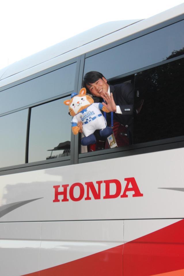 　指名あいさつを受け寮に止められたバスの中からポーズをとるＤｅＮＡ・片山