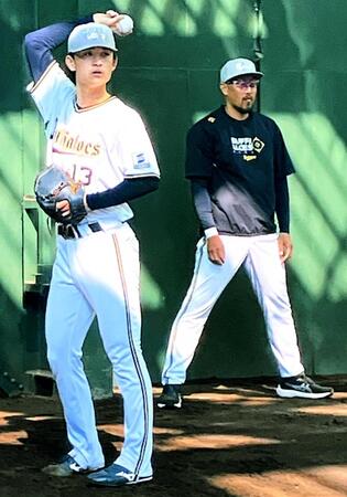 　ブルペンで投球する寺西。右は平野兼任投手コーチ