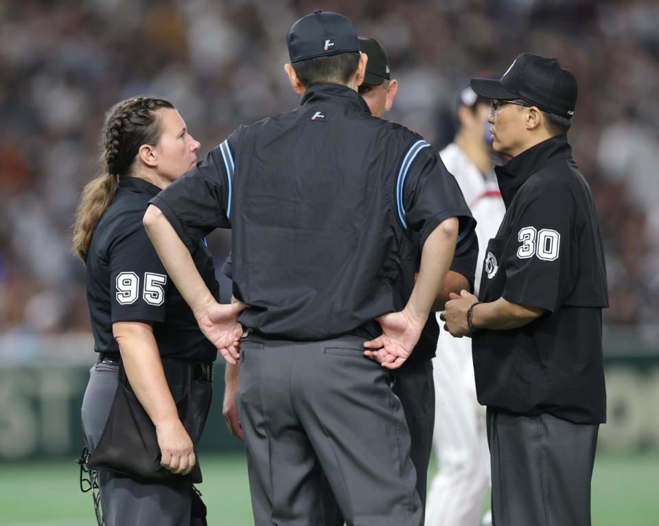 　５回、判定について話し合う審判団（撮影・西岡正）