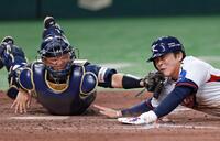 　７回、朴海旻の中前打で本塁を狙う文賢彬（右）をタッチアウトにする捕手・中村