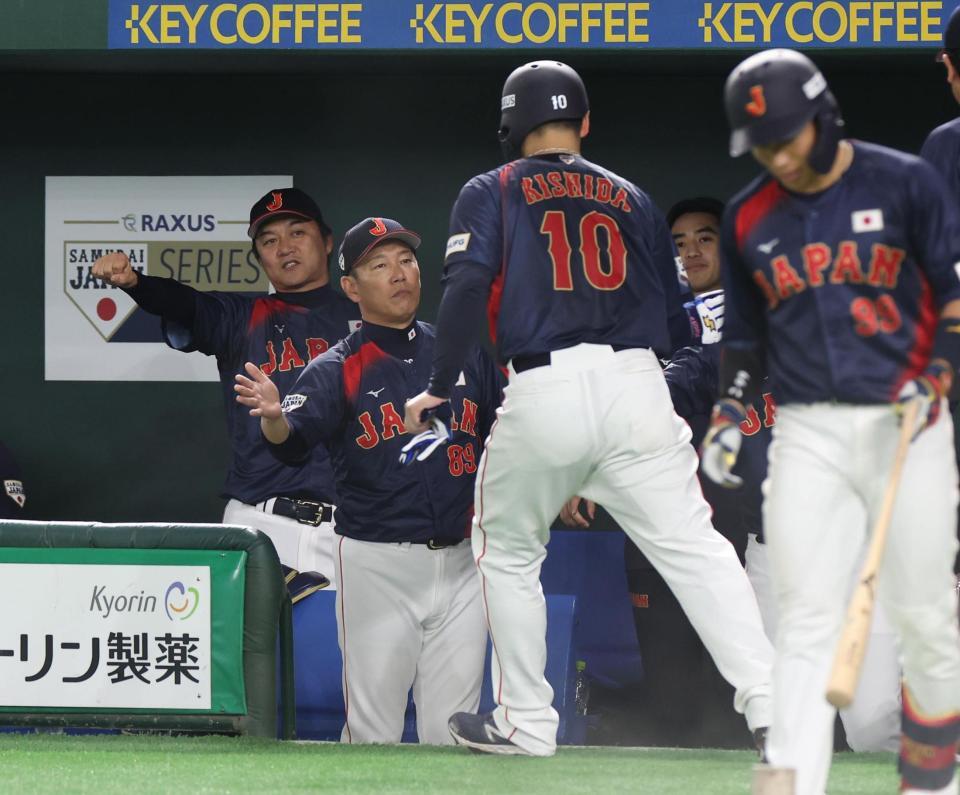 　４回、五十幡の押し出し四球で三走・岸田が生還。出迎える井端監督（撮影・佐々木彰尚）