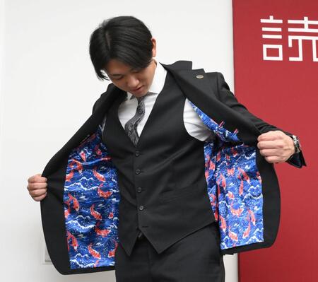 　着てきたスーツの裏地を見せる平内（撮影・伊藤笙子）