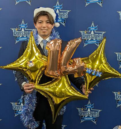 　クリスマスグッズを手に笑顔の東