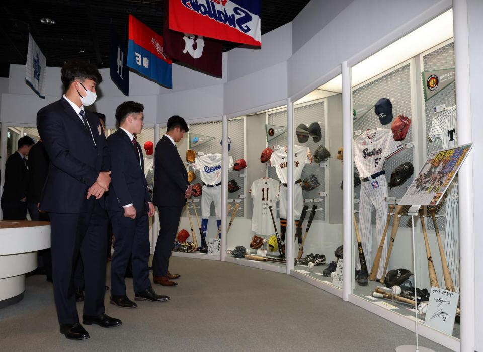 展示品を見つめる立石（手前）ら阪神とＤｅＮＡの選手たち撮影・伊藤笙子）