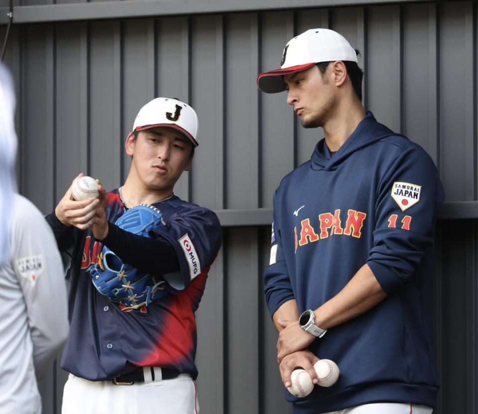 ブルペンでの投球を終え、ダルビッシュ（右）にアドバイスを求める隅田（撮影・伊藤笙子）