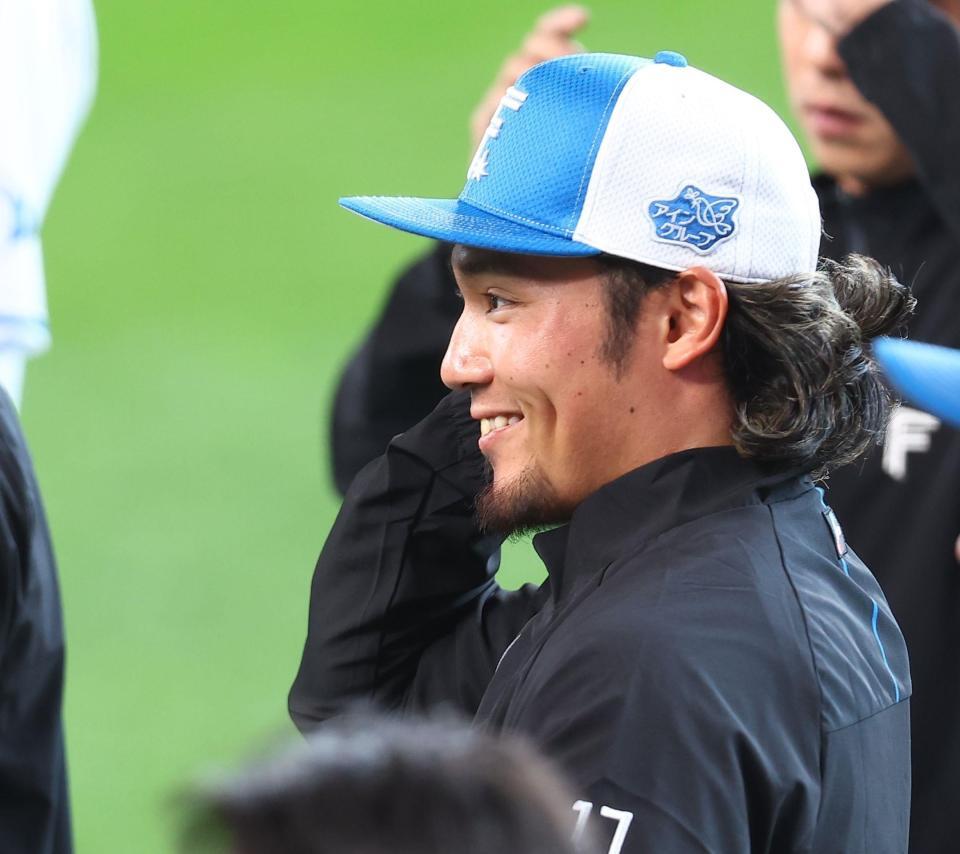 練習前、ナインに迎えられ、笑顔を見せる伊藤（撮影・中島達哉）