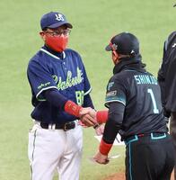 新庄監督（右）からプレゼントされた赤いマスクをしてメンバー表を交換し握手を交わす池山監督（撮影・中島達哉）