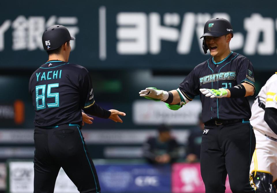 ３回、ソロを放ち、谷内内野守備走塁コーチ（左）に迎えられる清宮幸（撮影・中島達哉）