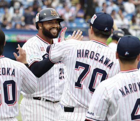 　７回、決勝２ランを放ちナインに迎えられるヤクルトのサンタナ＝神宮