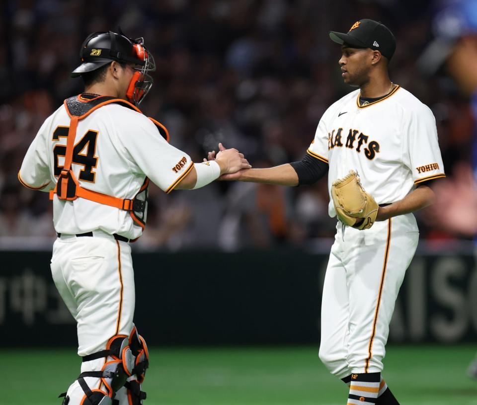 ９回を締め、大城（左）と握手を交わすマルティネス（撮影・伊藤笙子）