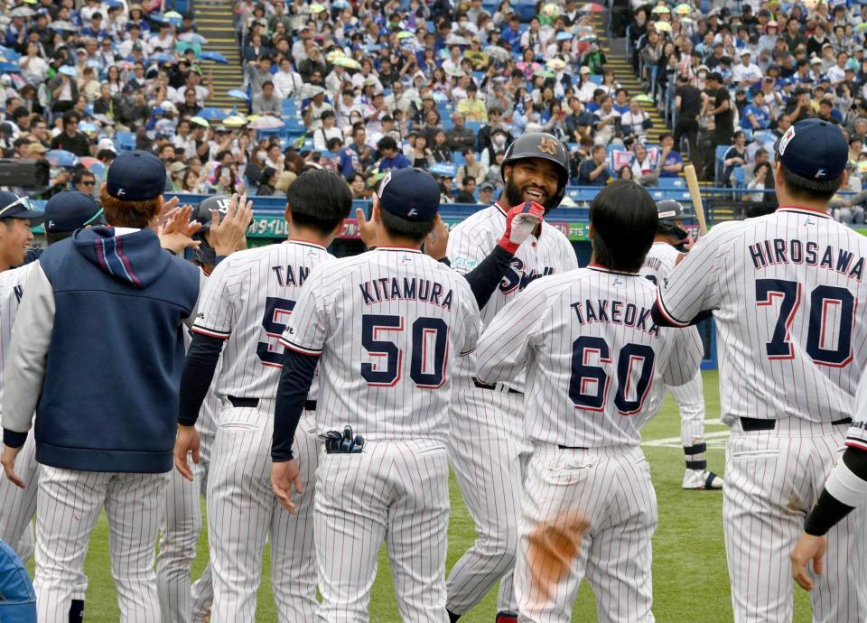 　７回、勝ち越し２ランを放ち、ナインに迎えられるサンタナ（撮影・持木克友）