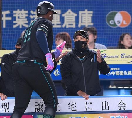 ４回、水野の右越え２点適時二塁打で勝ち越しのホームに生還したレイエス（左）とタッチを交わす新庄監督（撮影・開出牧）