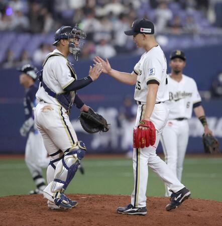 プロ初セーブをあげた椋木は森友とタッチを交わす（撮影・坂部計介）