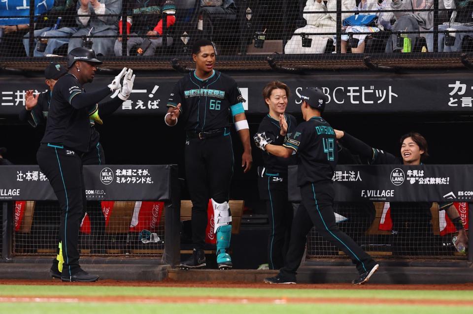 １回、レイエス（左から２人目）の同点犠飛で生還し、ナインに迎えられる大塚（右から２人目）＝撮影・中島達哉