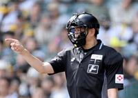 ヘルメットを着用する原球審