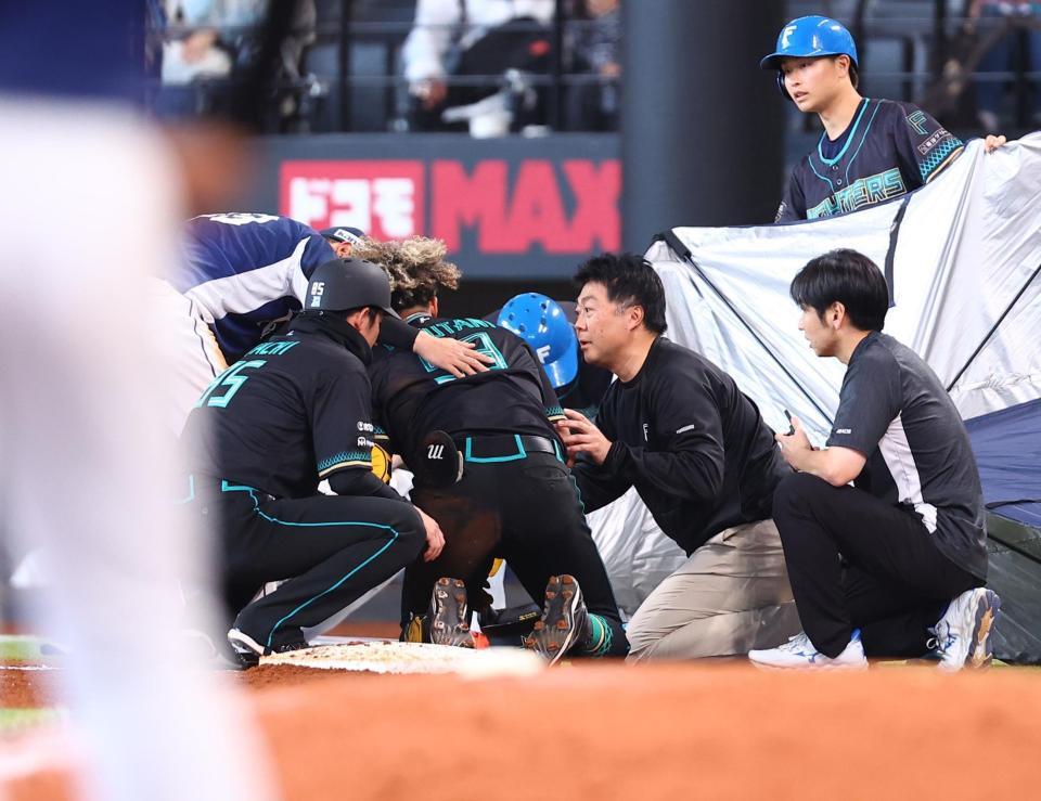 ７回、ゴロを処理し、平沢の本塁への送球が当たり、一塁でしゃがみ込む水谷（中央）＝撮影・中島達哉