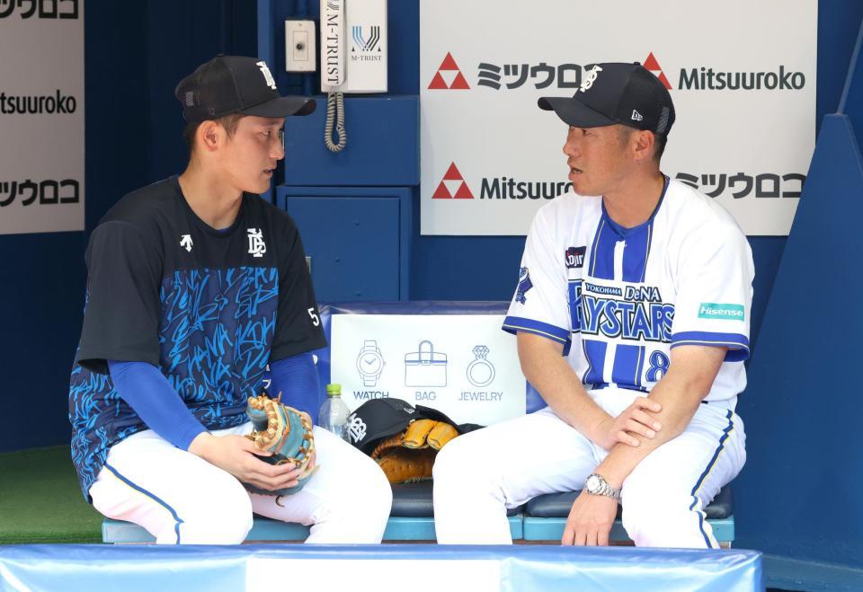 練習前、松尾（左）と話し込む相川監督＝１４日