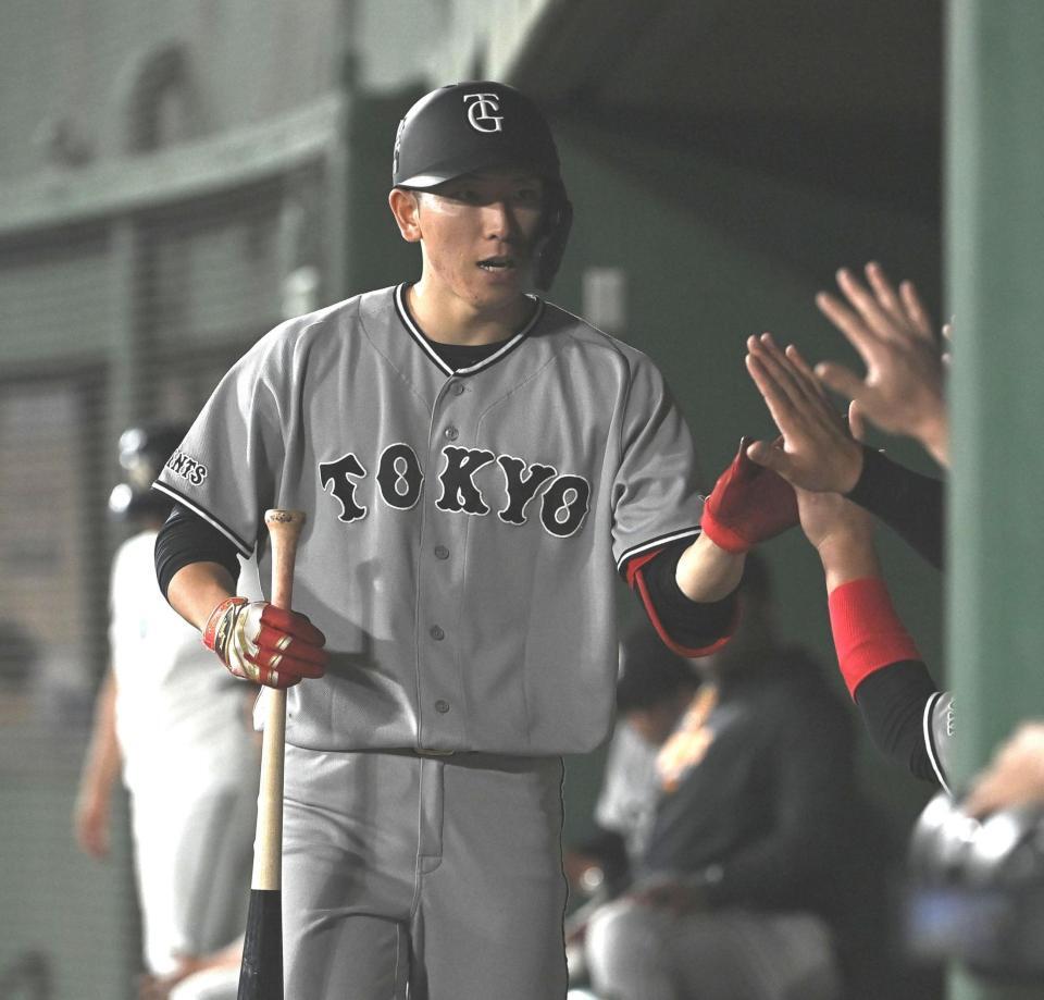 ７回、送りバントを決めナインとタッチを交わす戸郷（撮影・開出牧）