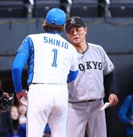 メンバー表を交換し、新庄監督（１）と握手を交わす橋上監督代行（撮影・中島達哉）