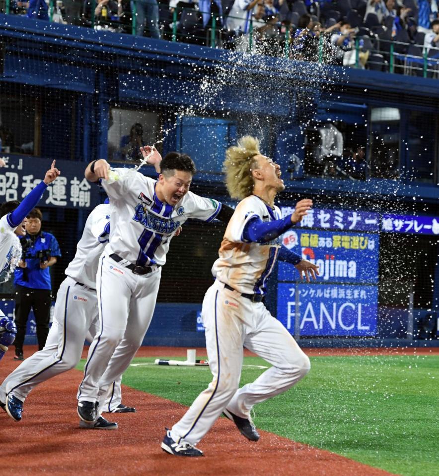 リプレー検証の結果、アウト判定が覆りサヨナラ勝ち。決勝のホームインを決めた三森（右）は牧（中央）から歓喜のシャワーを浴びる＝４日