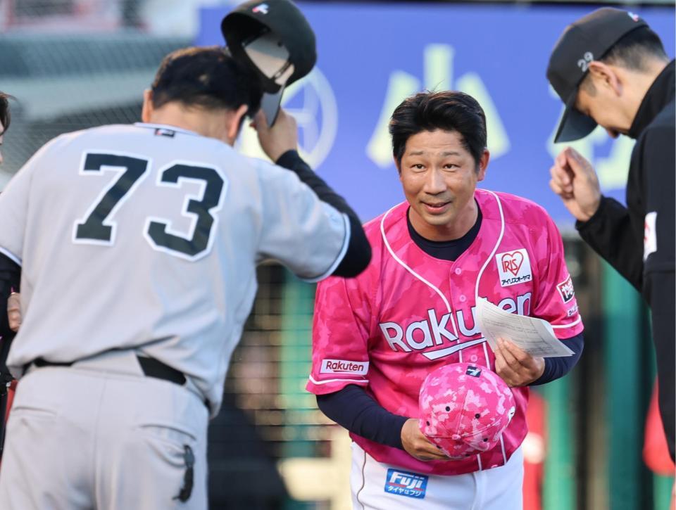 メンバー表を交換する塩川監督代行（右）と橋上監督代行
