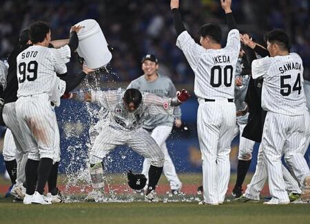 １０回、サヨナラの右前適時打を放ちナインから手洗い祝福を受ける佐藤（中央）＝撮影・開出牧