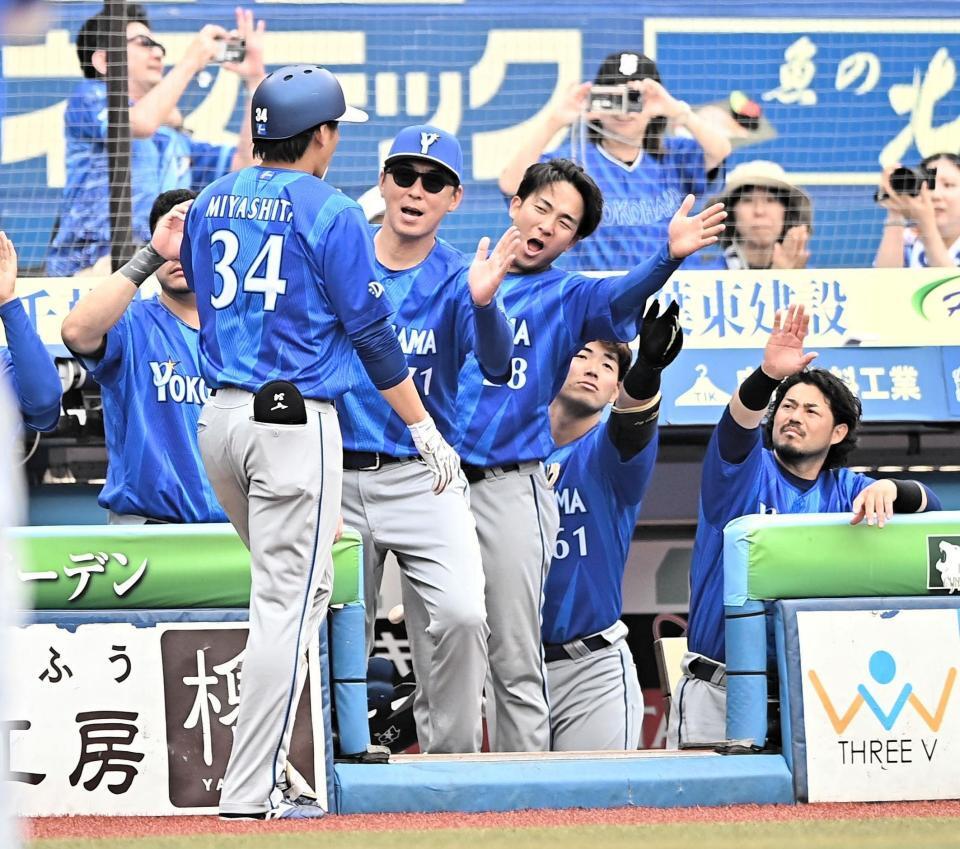 ８回、左越え２ランを放ちナインとタッチを交わす宮下（３４）＝撮影・開出牧