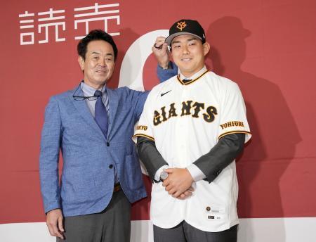　入団記者会見し、写真撮影に応じる巨人の小笠原（右）＝１８日、東京ドーム