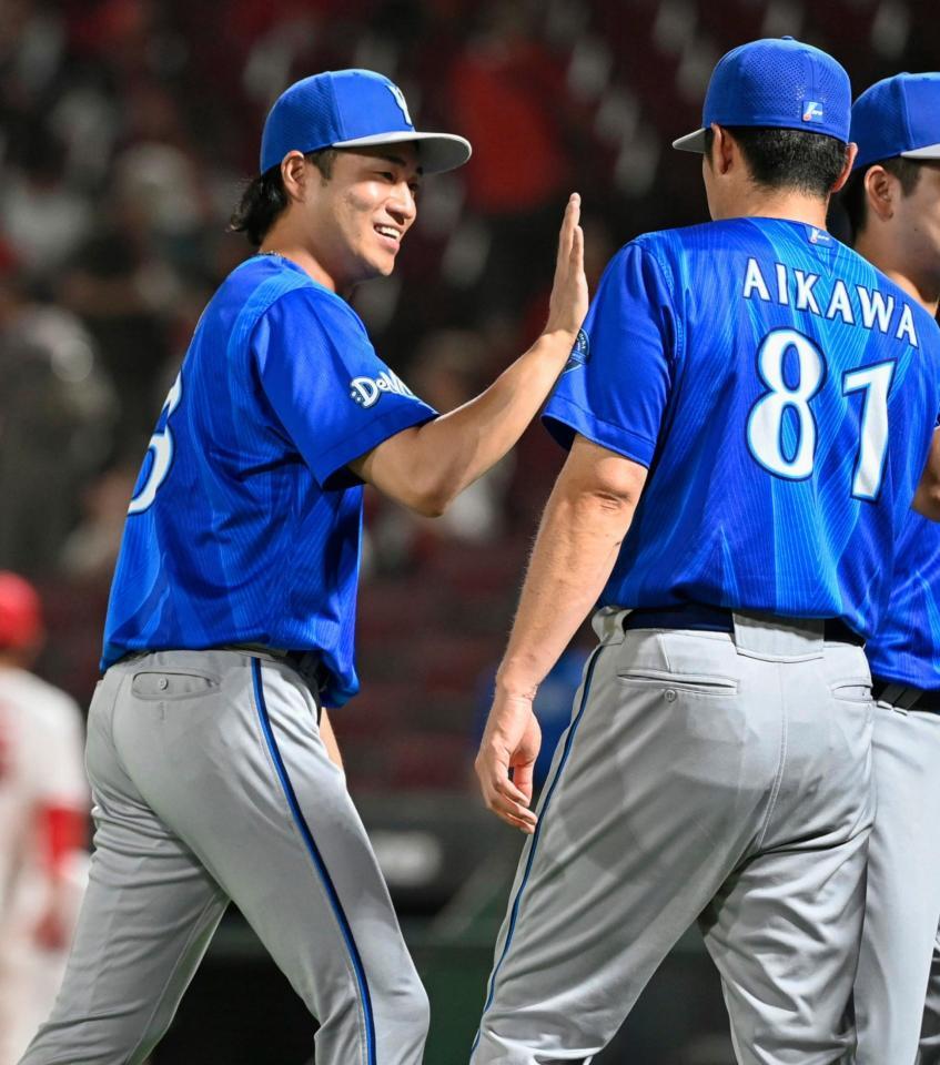 プロ初勝利を挙げ、相川監督とタッチする岩田