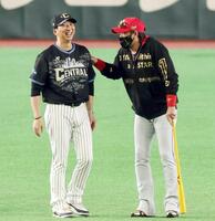 　試合前に談笑する藤川監督（左）と新庄監督
