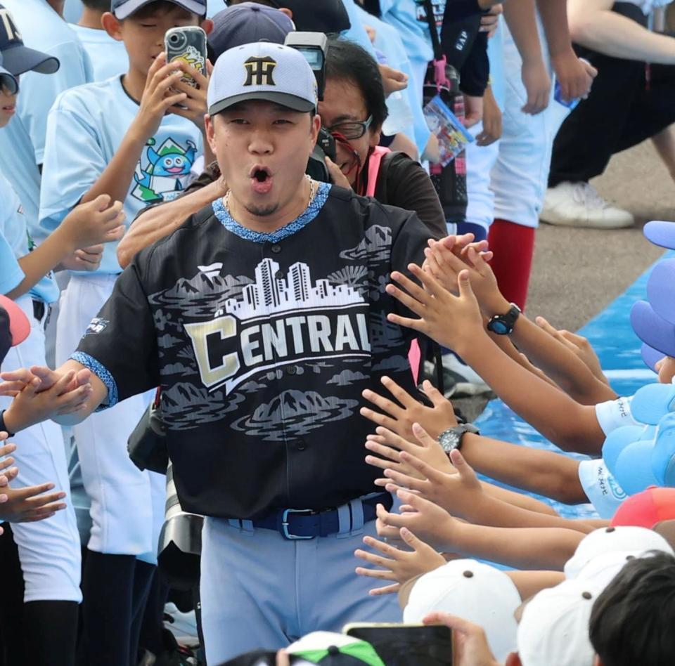 ブルーカーペットを大野大は阪神の帽子をかぶって入場する（撮影・山口登）