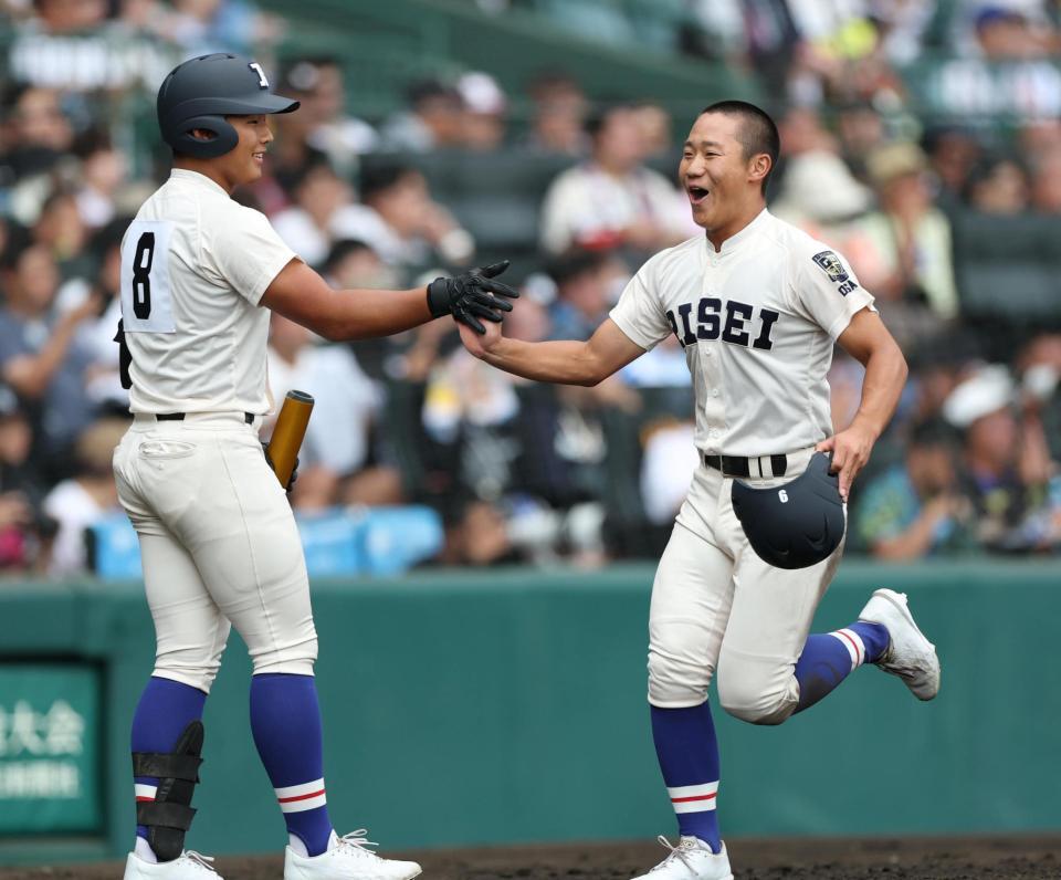 ４回の攻撃を終え、笑顔でベンチに戻る履正社・高津冬真（右）＝撮影・中田匡峻