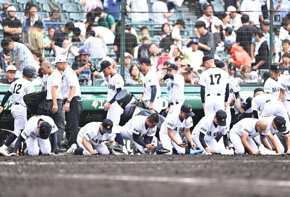 初戦突破ならず甲子園の土を集める佐賀商ナイン（撮影・開出牧）